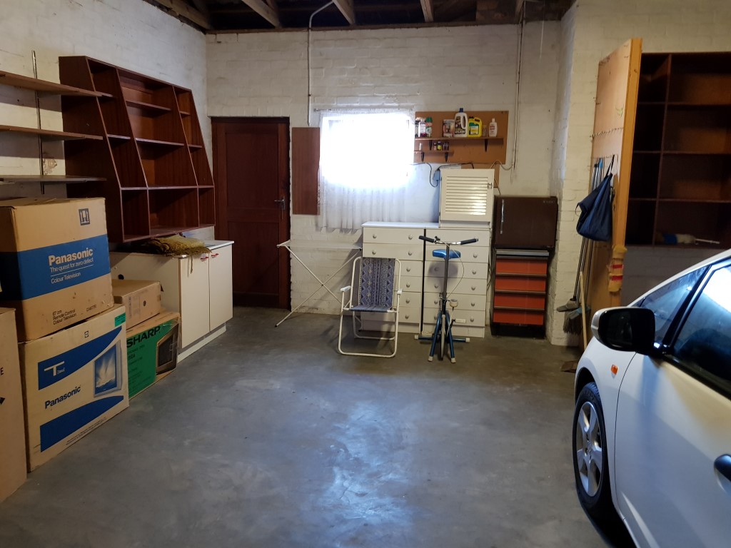 View through Garage to Door leading to Front Patio